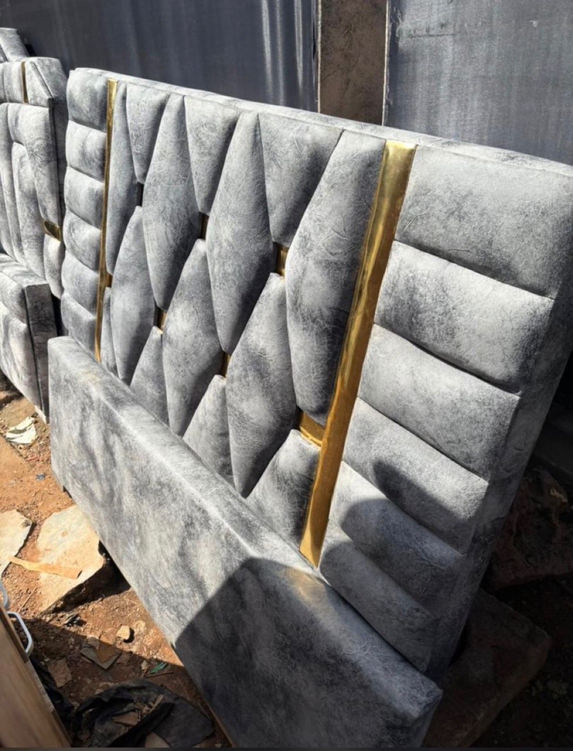 Grey upholstered headboards with gold strips
