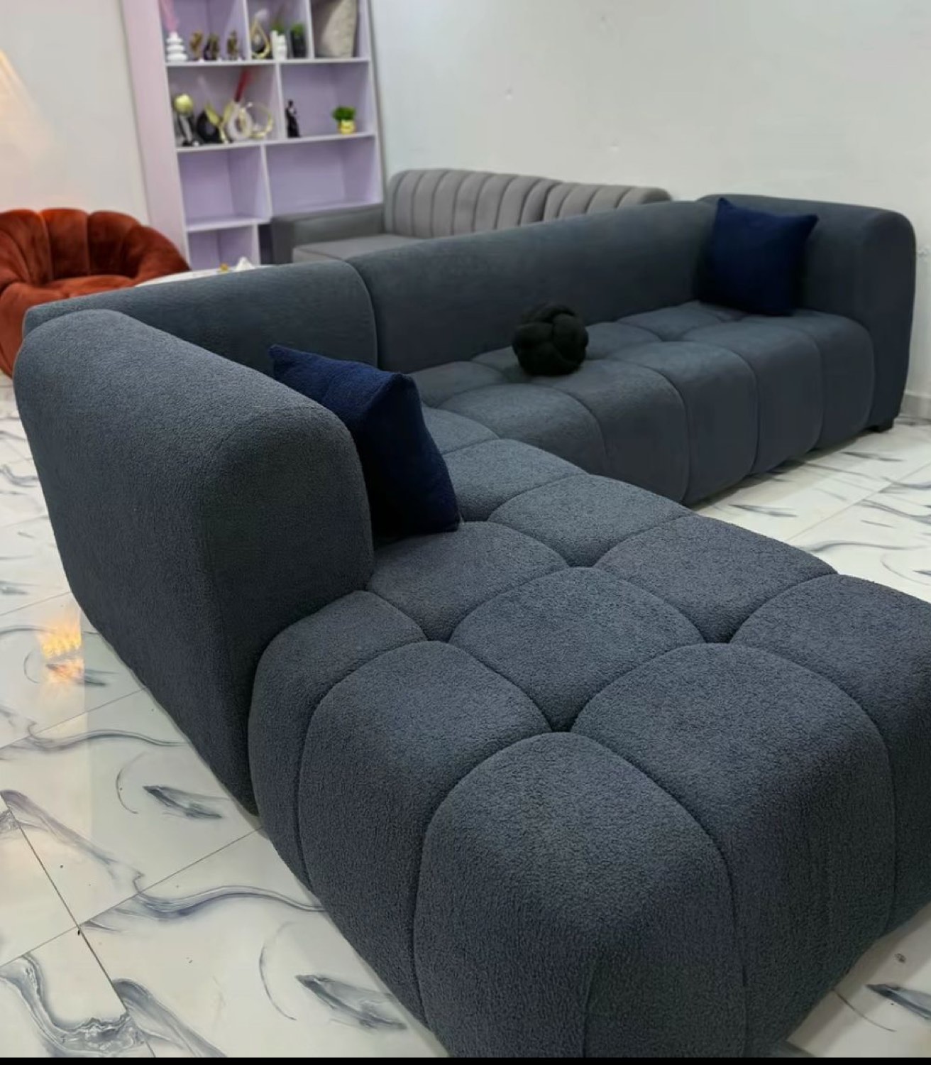 Navy bouclé sectional sofa in a finished Kumasi home